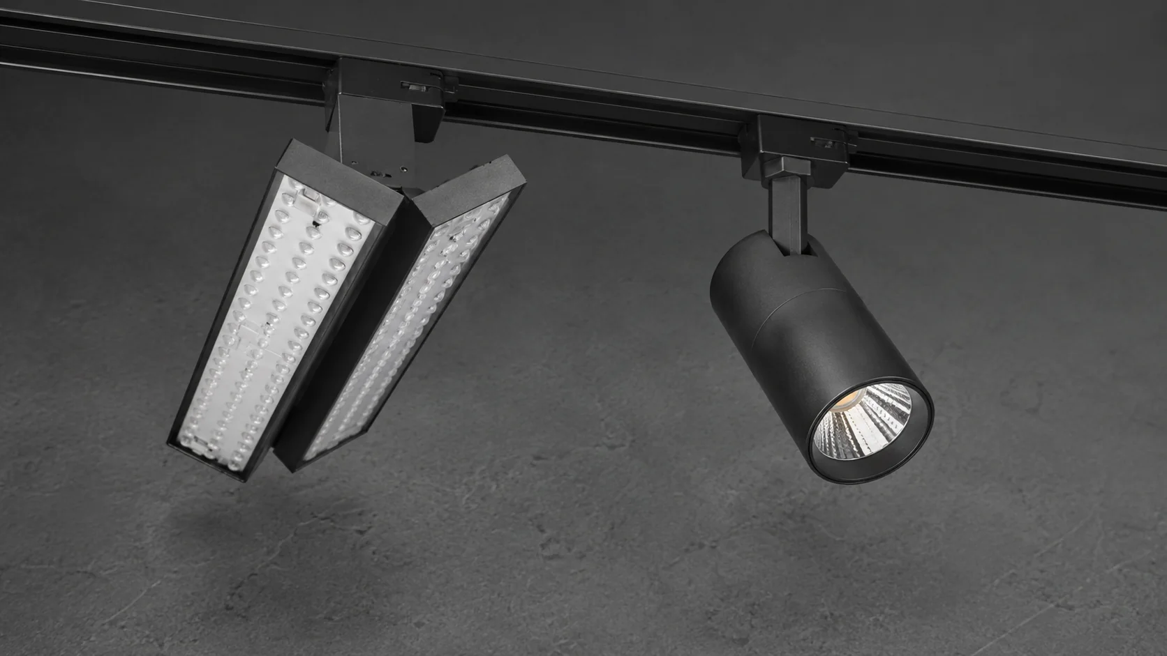 Dual-panel track light beside a traditional spotlight