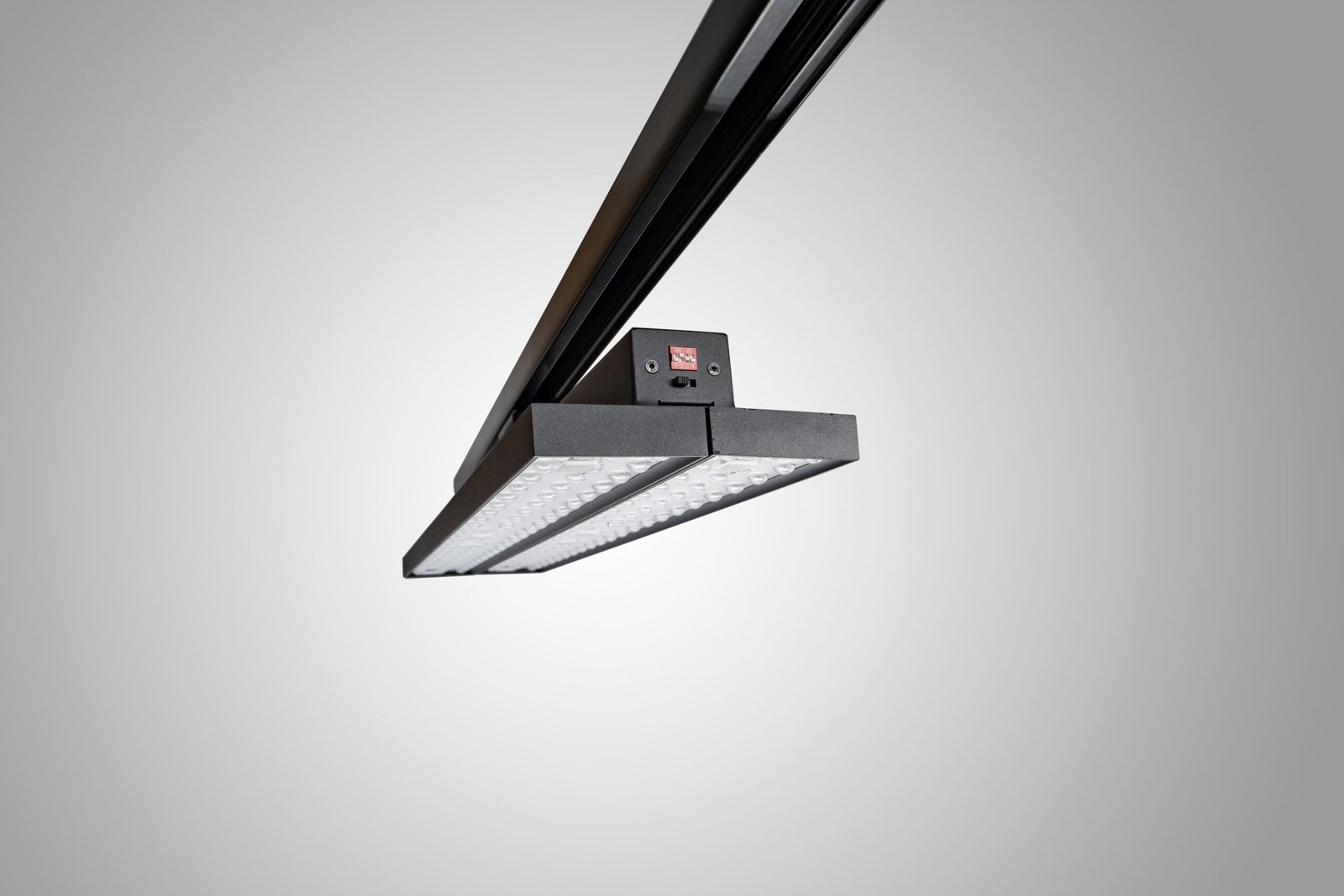 Installed dual-panel track light viewed from below for glare and sightline assessment
