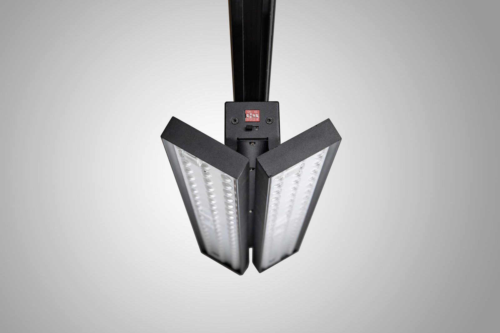 Dual-panel LED track light with both panels opened symmetrically for separate aiming
