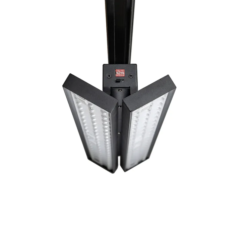 Dual-panel track light opened for wide directional lighting